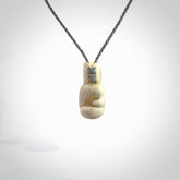 Hand carved boxing glove made from deer antler. The cord is adjustable so that you can wear this where it suits you best.
